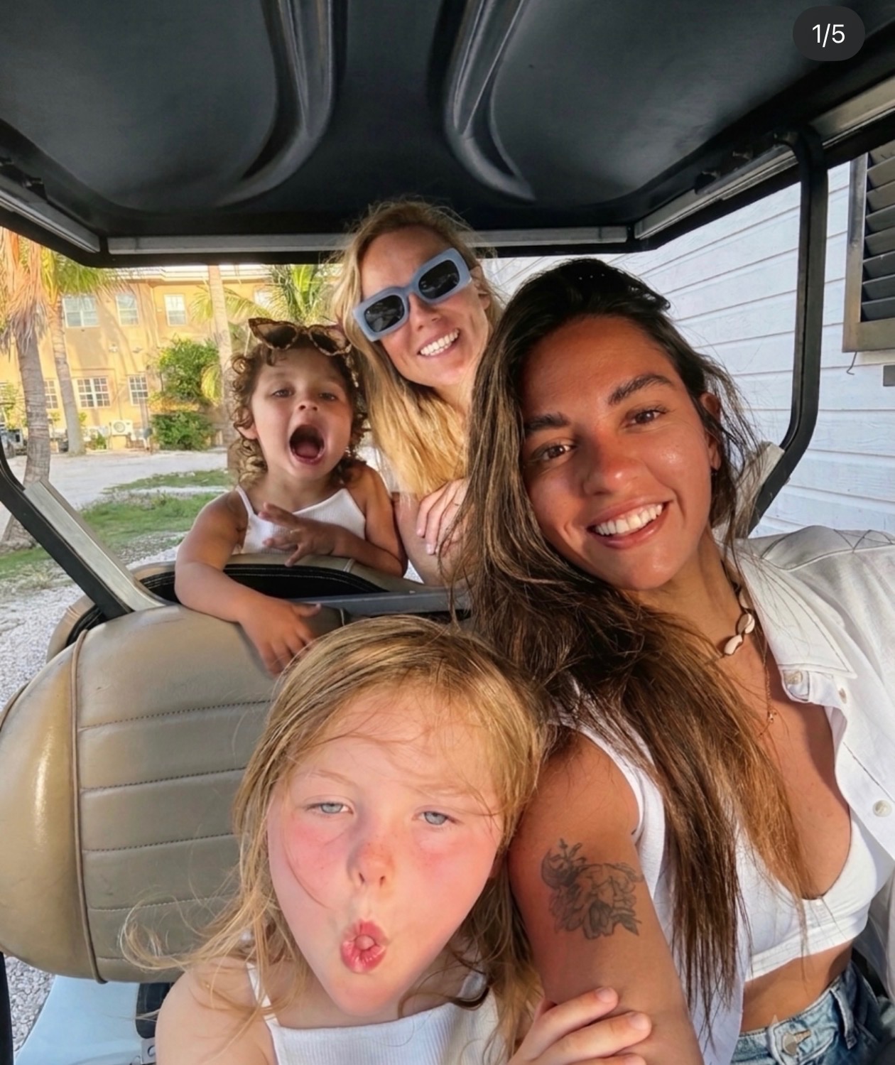 Morgan and Ale with their two daughters in a golf cart