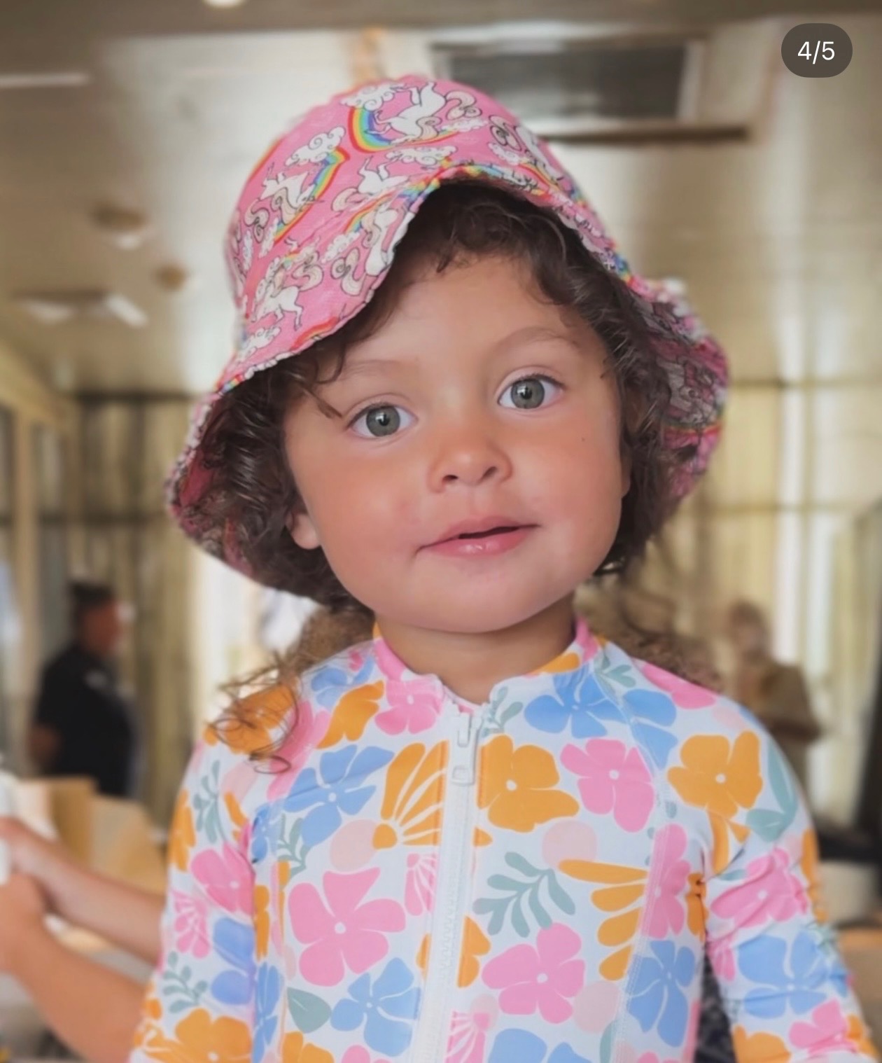 Their younger daughter in a sun hat