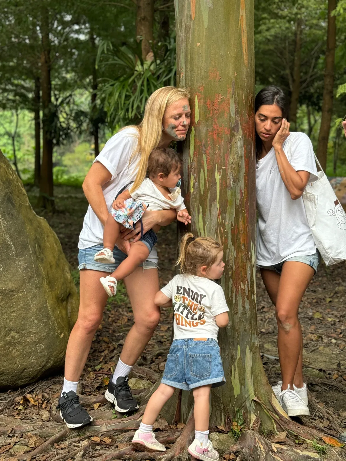 Morgan and Ale exploring a shady forest trail with their two children