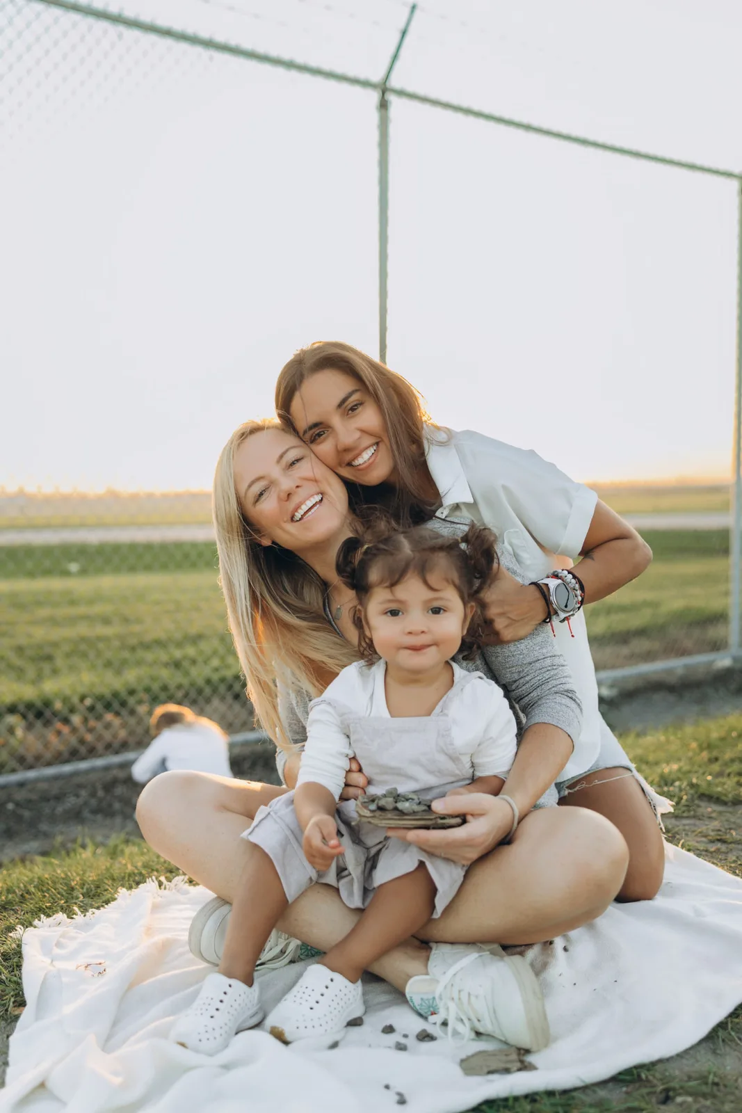 Our family sharing a picnic together at sunset on the coast